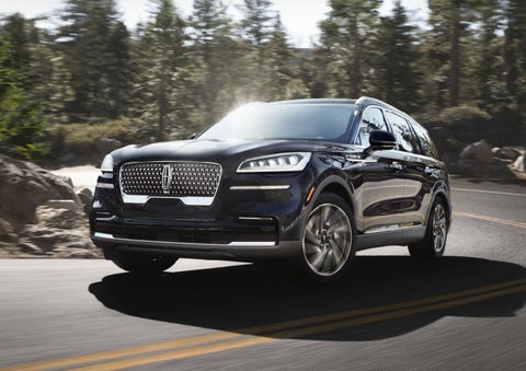 A Lincoln Aviator® SUV is being driven on a winding mountain road | Irwin Lincoln Laconia in Laconia NH