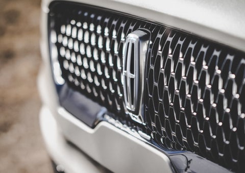 The grille of the 2024 Lincoln Aviator® Reserve model with an eye-catching repeated field of Lincoln Star logo shapes | Irwin Lincoln Laconia in Laconia NH