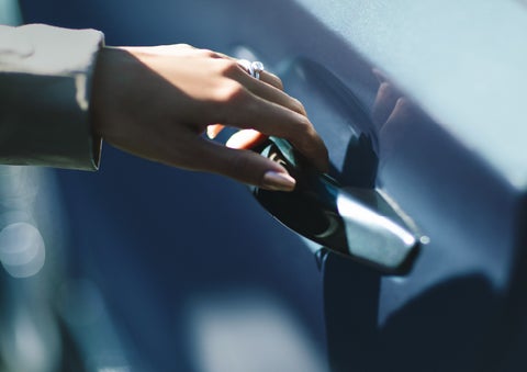 A hand gracefully grips the Light Touch Handle of a 2024 Lincoln Aviator® SUV to demonstrate its ease of use | Irwin Lincoln Laconia in Laconia NH
