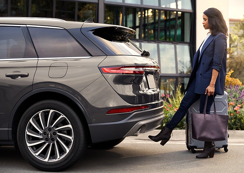 A woman with her hands full uses her foot to activate the available hands-free liftgate. | Irwin Lincoln Laconia in Laconia NH