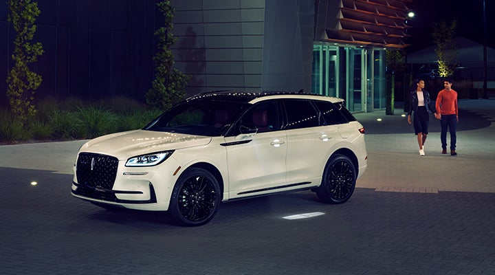 Two people approach a 2024 Lincoln Corsair® SUV featuring the available Jet Appearance Package. | Irwin Lincoln Laconia in Laconia NH