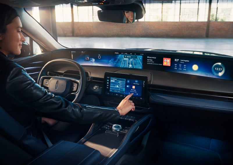 The driver of a 2024 Lincoln Nautilus® SUV interacts with the center touchscreen. | Irwin Lincoln Laconia in Laconia NH