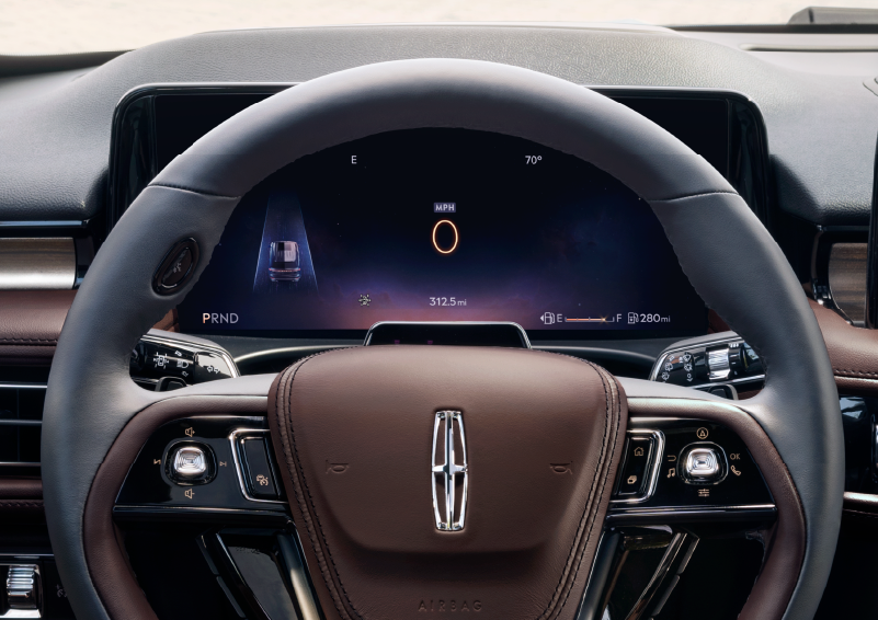 The steering wheel of 2025 Lincoln Aviator® SUV is shown with black and brown accents. | Irwin Lincoln Laconia in Laconia NH