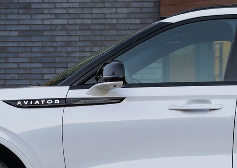 The driver’s side door and fender badging of a white 2026 Lincoln Aviator® SUV are showcased. | Irwin Lincoln Laconia in Laconia NH