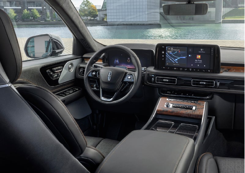 The interior of the 2026 Lincoln Aviator® SUV is shown parked with a view of a harbor through the windshield. | Irwin Lincoln Laconia in Laconia NH