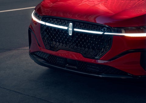 The available front LED light bar and center Lincoln Star logo glow at dusk. | Irwin Lincoln Laconia in Laconia NH