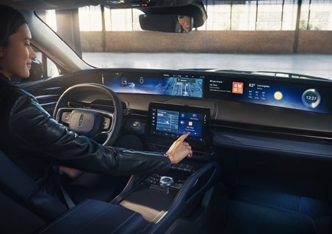 The driver of a 2026 Lincoln Nautilus® SUV interacts with the center touchscreen. | Irwin Lincoln Laconia in Laconia NH