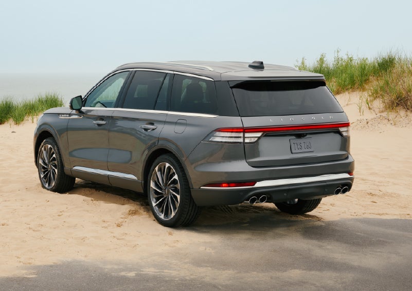 A 2027 Lincoln Aviator® SUV is parked next to sand dunes. | Irwin Lincoln Laconia in Laconia NH