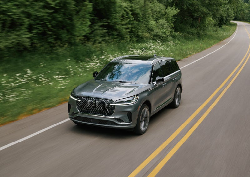 A 2027 Lincoln Aviator® SUV is being driven down a road. | Irwin Lincoln Laconia in Laconia NH