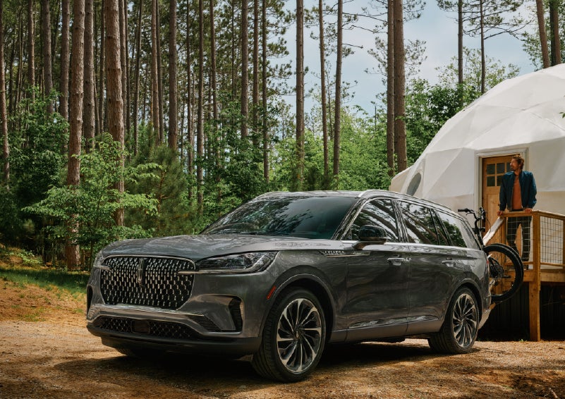 A 2027 Lincoln Aviator® is parked next to a high end glamping site. | Irwin Lincoln Laconia in Laconia NH