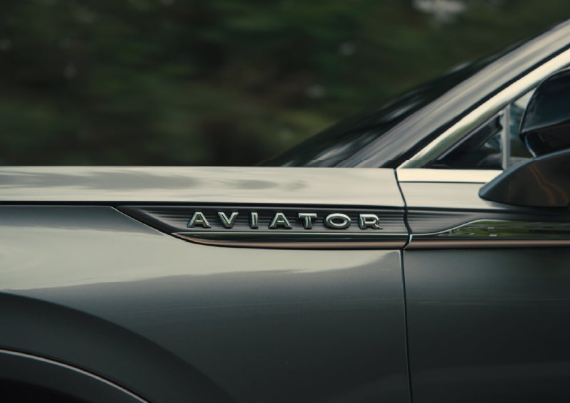 The driver’s side door and fender badging of a gray 2027 Lincoln Aviator® SUV are showcased. | Irwin Lincoln Laconia in Laconia NH