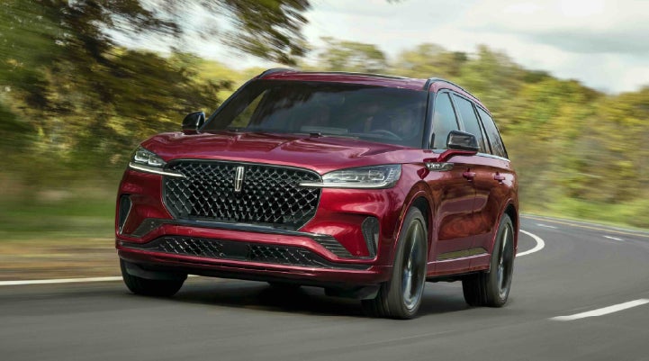 A 2027 Lincoln Aviator® SUV is being driven on a country road | Irwin Lincoln Laconia in Laconia NH