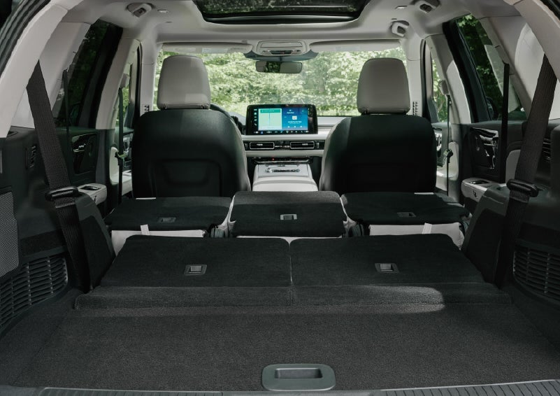A rear to front view of the interior of a 2027 Lincoln Aviator® Black Label™ SUV shows the third and second rows folded flat | Irwin Lincoln Laconia in Laconia NH