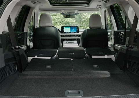 A rear to front view of the interior of a 2027 Lincoln Aviator® Black Label™ SUV shows the third and second rows folded flat | Irwin Lincoln Laconia in Laconia NH