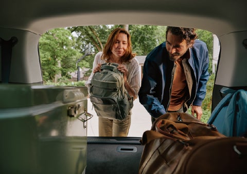 A couple loads luggage into the rear of a 2027 Lincoln Aviator® Black Label™ SUV..e 202 | Irwin Lincoln Laconia in Laconia NH
