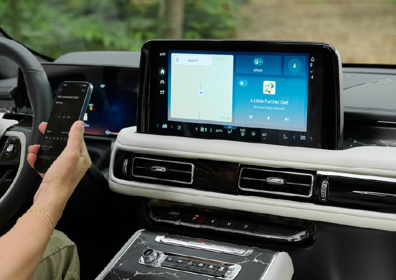 A person pairs thier phone with the center touchscreen of a 2027 Lincoln Aviator® Black Label™ SUV | Irwin Lincoln Laconia in Laconia NH